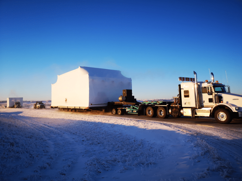 Modular building unit hauled by truck